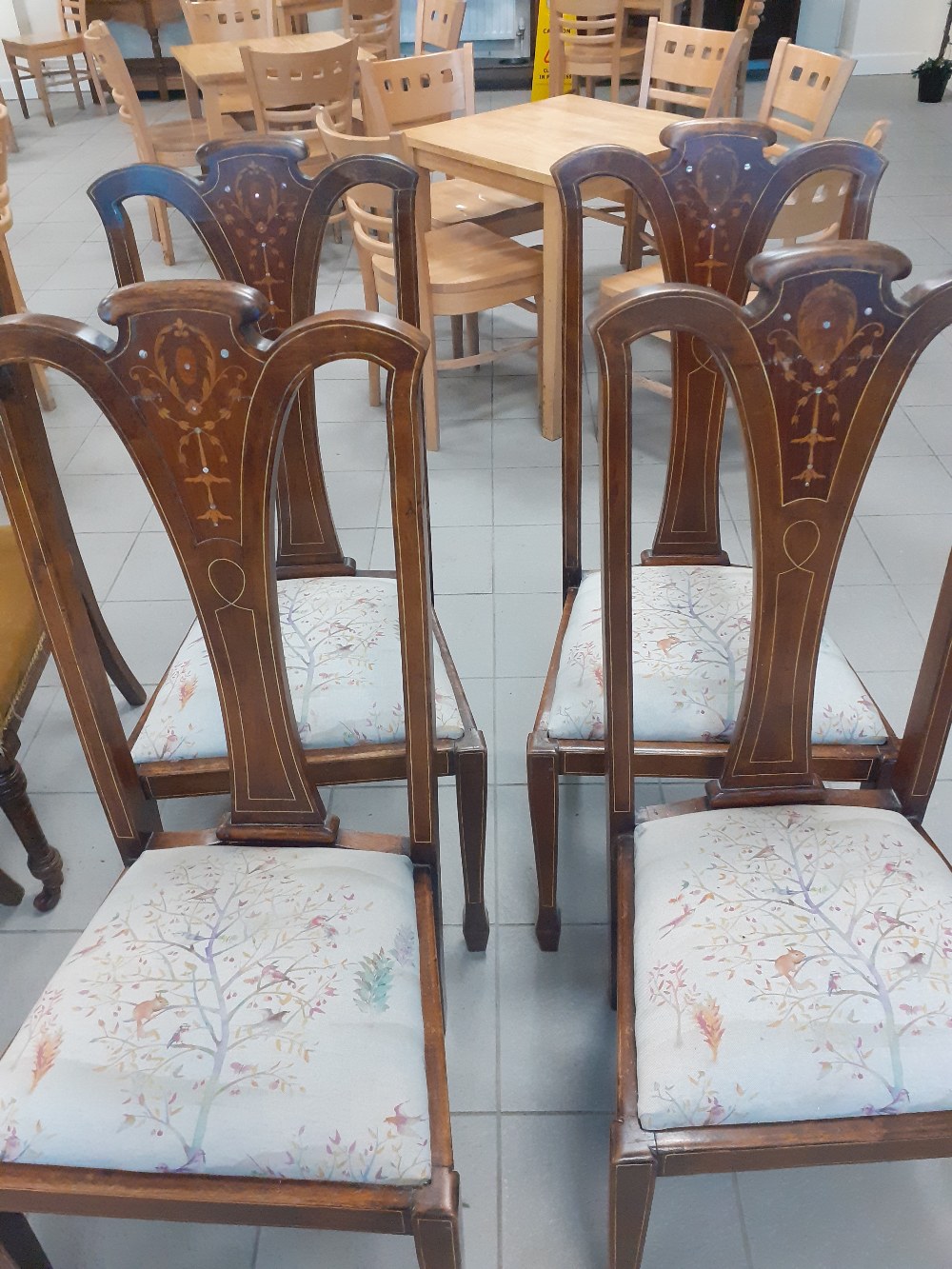 Four Edwardian dining chairs with inlaid splat backs