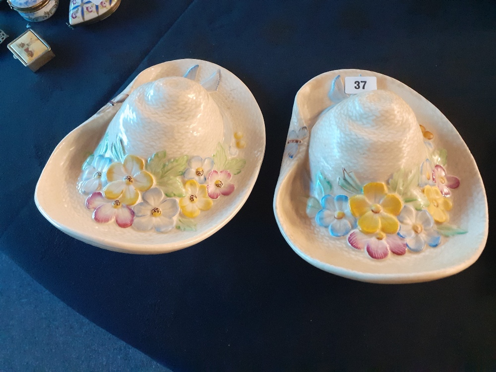 A pair of Beswick wall pockets in the shape of floral straw hats.