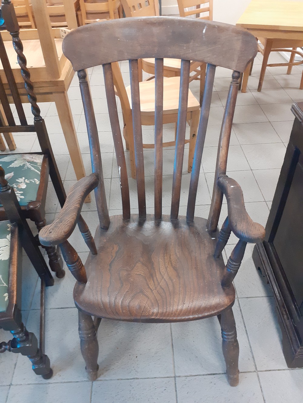 A Victorian beech kitchen armchair.