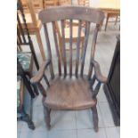 A Victorian beech kitchen armchair.