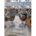 A pair of Victorian Hand painted classical style vases with panels of women and painted flowers.