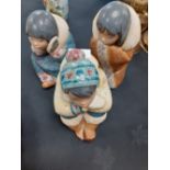 A three Ladro figures of indigenous people.