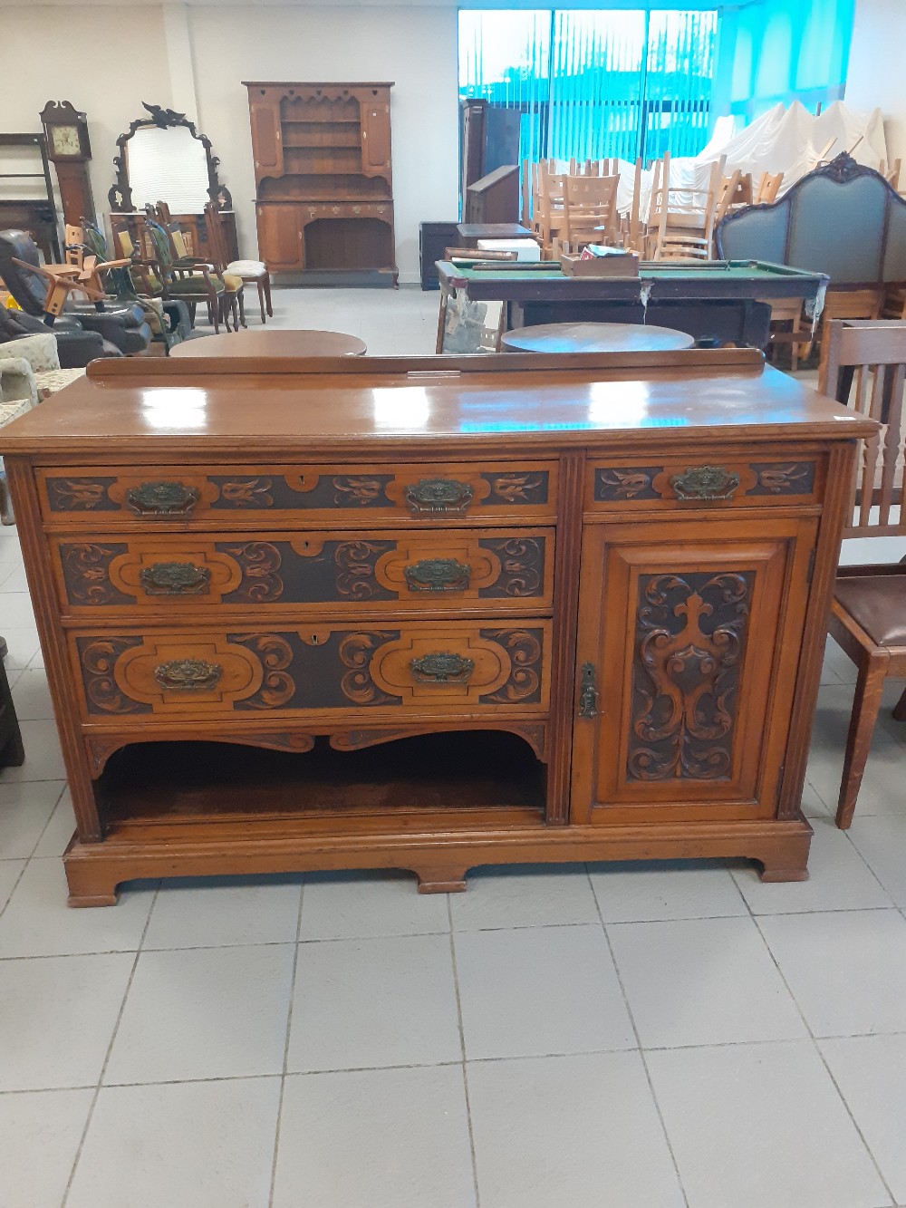 A Victorian Mahogany carved sideboard with four drawers and a cupboard.22"x59"x58"