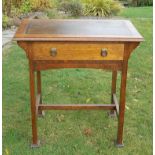 A small arts and crafts desk with leather insert.