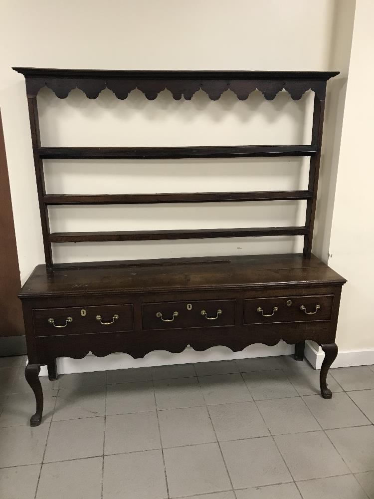 A late 18TH/early 19th century oak three drawer dresser