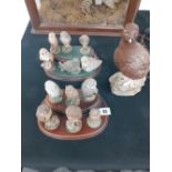 A collection of Royal Doulton Owls mounted on stands together with a Doulton grouse whiskey bottle.