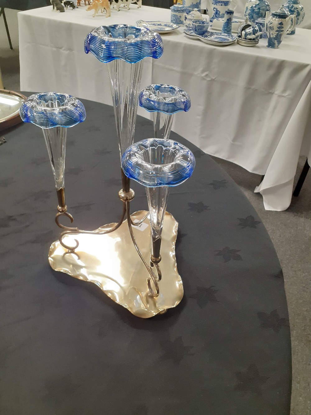 An Edwardian silver plated epergne with clear and blue glass trumpets.