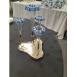 An Edwardian silver plated epergne with clear and blue glass trumpets.
