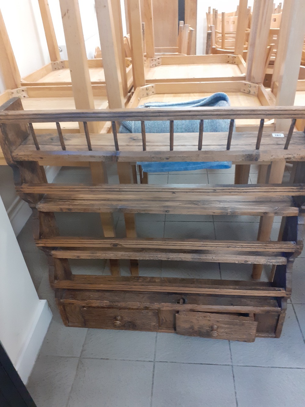 A Victorian pine plate rack with two drawers.