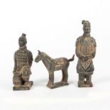 THREE JAPANESE EBONY CLAY FIGURES, TWO MEN, ONE HORSE