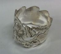 An attractive Edwardian silver napkin ring with fl