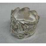 An attractive Edwardian silver napkin ring with fl