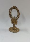 A small silver gilt Continental picture frame on o