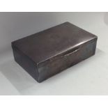 A rectangular engine turned silver cigarette box.