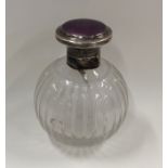 An enamel topped silver scent bottle with stopper.