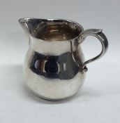 A heavy silver cream jug on flat base. London. By