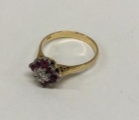 An attractive 18 carat ruby and diamond daisy head