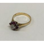 An attractive 18 carat ruby and diamond daisy head