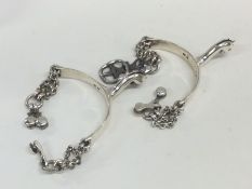 A pair of rare Georgian silver spurs with chain li