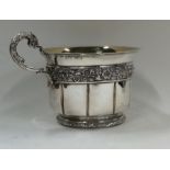 A Georgian silver and silver gilt cup decorated wi