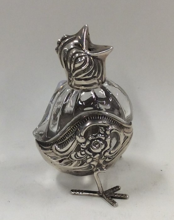 An unusual silver pepper in the form of a chick wi