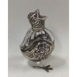 An unusual silver pepper in the form of a chick wi