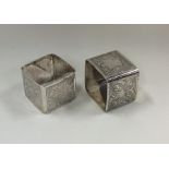 A pair of Victorian silver napkin rings decorated