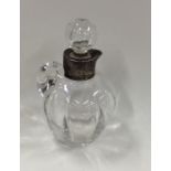 A silver mounted glass cream tot with pouring lip.