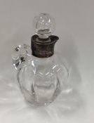 A silver mounted glass cream tot with pouring lip.