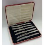 A boxed set of six silver knives with steel blades