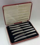 A boxed set of six silver knives with steel blades