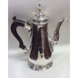 A massive Georgian silver coffee pot with crested