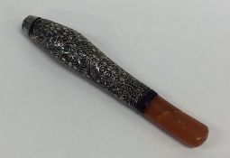 A Continental amber mounted cigarette holder with