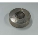 A small circular engine turned silver box with gil