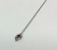 A stylish 18 carat gold ruby and diamond pendant w