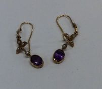 A pair of amethyst and pearl drop earrings in gold