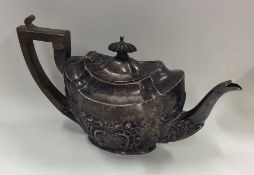 An embossed bachelor's three piece silver teapot.