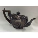 An embossed bachelor's three piece silver teapot.