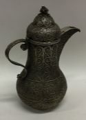 An unusual Islamic silver jug and cover with wire