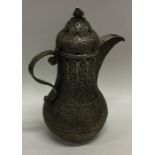 An unusual Islamic silver jug and cover with wire