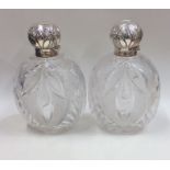 A pair of massive silver hobnail cut scent bottles