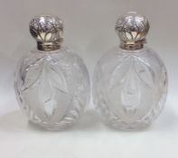 A pair of massive silver hobnail cut scent bottles