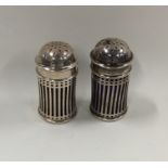 A pair of Edwardian silver pierced peppers with li