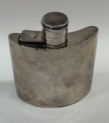 A small silver hip flask with hinged top. London.