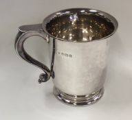 A silver tankard of tapering form on spreading bas