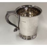 A silver tankard of tapering form on spreading bas