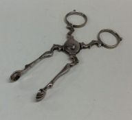 A pair of Georgian scissor action silver tongs of