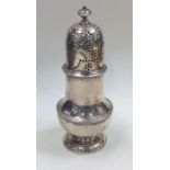 A heavy George II silver caster with lift-off cove