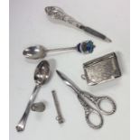 A bag containing silver spoons, scissors etc. Appr