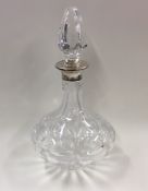A silver and cut glass decanter together with stop